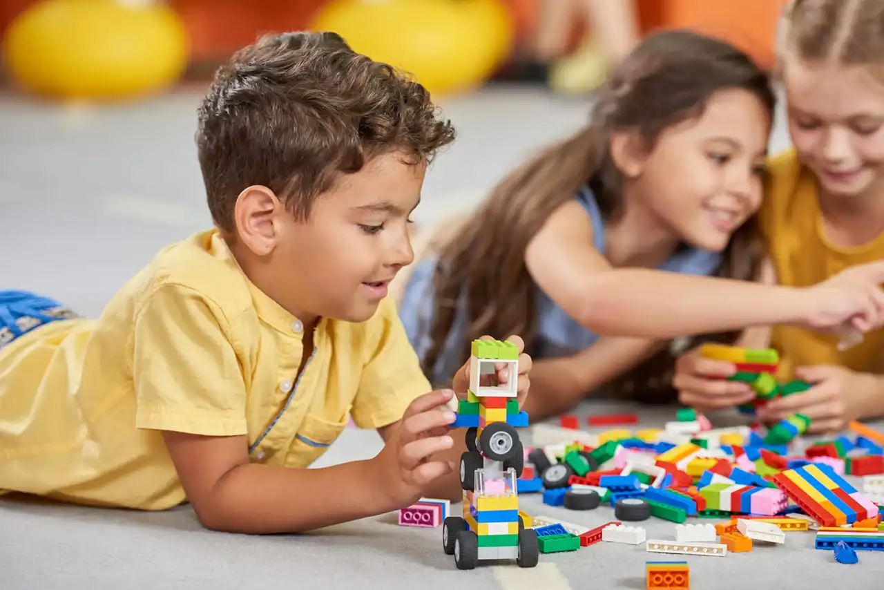bigstock-Kids-Playing-Block-Toys-In-Pla-350958596